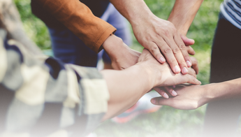 team huddle with hands in the center