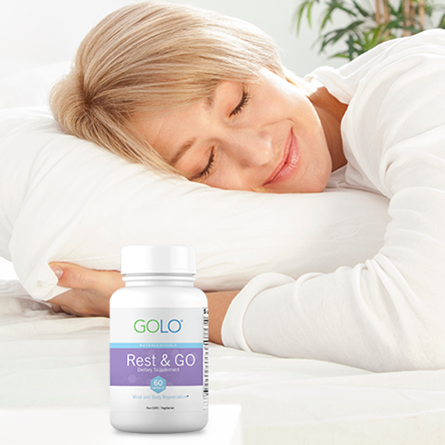 woman doing an sleeping with bottle of GOLO Rest & GO on bedside table